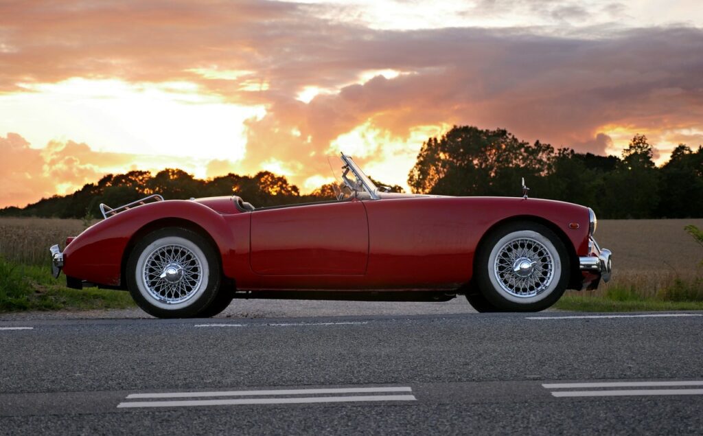 Red Sports Car traveling on Midsouth highway road - Summer Road Trip