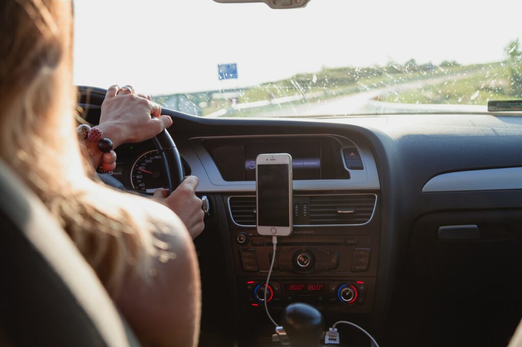 Woman Driving with Cell Phone GPS - Summer Road Trip